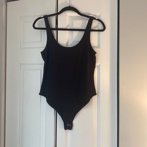 NWOT. Woman’s Forever21 black bodysuit. Size large.